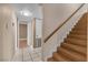 A bright stairway with wood treads and a wood handrail is adjacent to an open doorway to another room at 7604 Charles Conrad Cir, Las Vegas, NV 89145