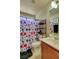 Functional bathroom includes a vanity, toilet, and shower/tub combo with a stylish floral shower curtain at 8022 Severn Valley St, Las Vegas, NV 89139