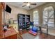 This bedroom features wood floors, window shutters, and exercise equipment at 8022 Severn Valley St, Las Vegas, NV 89139