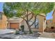 Charming home exterior featuring a well-manicured yard, mature trees, a desert landscaped yard and an attached garage at 8022 Severn Valley St, Las Vegas, NV 89139