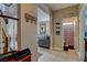 Hallway featuring tile floors and staircase view with view into the living room and an adjacent powder room at 8022 Severn Valley St, Las Vegas, NV 89139