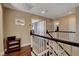 Upstairs hallway with beautiful wood floors and white railing, leading to bedrooms and other living spaces at 8022 Severn Valley St, Las Vegas, NV 89139