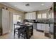 Bright kitchen boasts stainless appliances, white cabinets, and kitchen island at 8022 Severn Valley St, Las Vegas, NV 89139