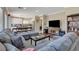 Open concept living and kitchen space, hardwood floors, natural light and plush sectional couch at 8022 Severn Valley St, Las Vegas, NV 89139