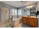 Bright main bathroom with a walk-in shower, soaking tub, double vanity and shuttered windows at 8022 Severn Valley St, Las Vegas, NV 89139