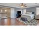 Beautifully decorated main bedroom with dark wood floors, neutral colors, and a view into the hallway at 8022 Severn Valley St, Las Vegas, NV 89139