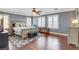 Bright main bedroom with wood floors, shuttered windows, ceiling fan and a neutral color palette at 8022 Severn Valley St, Las Vegas, NV 89139