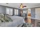 Spacious main bedroom features wood floors, neutral gray walls, and an arched entryway to the ensuite bathroom at 8022 Severn Valley St, Las Vegas, NV 89139