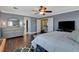 Main bedroom with dark wood flooring, large bed, gray walls and a ceiling fan for optimal comfort at 8022 Severn Valley St, Las Vegas, NV 89139