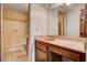Bathroom featuring a sink vanity, large mirror, and combination shower and bathtub at 804 S Mallard St, Las Vegas, NV 89107