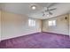 Spacious bedroom with purple carpeting, neutral walls, and ceiling fan, providing a comfortable and inviting atmosphere at 804 S Mallard St, Las Vegas, NV 89107