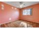 A cozy bedroom with a ceiling fan and window providing natural light at 804 S Mallard St, Las Vegas, NV 89107
