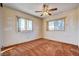 Bedroom filled with natural light from two windows and features a ceiling fan at 804 S Mallard St, Las Vegas, NV 89107