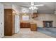Charming kitchen featuring wood cabinets, white appliances, and tiled floor open to a living area with a fireplace at 804 S Mallard St, Las Vegas, NV 89107