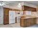 Bright kitchen with wood cabinets, white appliances, and tiled flooring offering functionality and style at 804 S Mallard St, Las Vegas, NV 89107