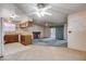 Bright kitchen flows to living area featuring tile flooring, ceiling fans, and sliding glass door to backyard at 804 S Mallard St, Las Vegas, NV 89107