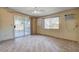 Bright living room featuring tiled floors, neutral walls, and a sliding glass door leading to the patio at 804 S Mallard St, Las Vegas, NV 89107