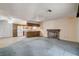 Spacious living room featuring carpeted floors, a cozy brick fireplace, and an open layout at 804 S Mallard St, Las Vegas, NV 89107