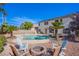 A backyard featuring a pool, spa, and firepit area with lounge seating at 8321 Gorsky Ave, Las Vegas, NV 89131