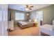 Cozy bedroom showcasing a window, ceiling fan, and light green paint at 8321 Gorsky Ave, Las Vegas, NV 89131