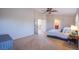 Spacious bedroom features neutral colors, ceiling fan, and adjacent bathroom at 8321 Gorsky Ave, Las Vegas, NV 89131