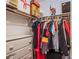 Well-organized closet with clothes hanging and storage boxes on the shelf at 8321 Gorsky Ave, Las Vegas, NV 89131