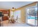 Charming kitchen nook with a view of the pool, a ceiling fan, and a cozy dining set at 8321 Gorsky Ave, Las Vegas, NV 89131