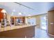 Bright kitchen with stainless appliances, granite counters, island, and backyard pool view at 8321 Gorsky Ave, Las Vegas, NV 89131