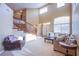 Spacious living room with a winding staircase, plush seating, and large windows for natural light at 8321 Gorsky Ave, Las Vegas, NV 89131