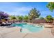 Inviting backyard pool and spa with poolside seating and lush landscaping at 8321 Gorsky Ave, Las Vegas, NV 89131