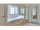 Relaxing bathroom featuring a soaking tub and glass shower enclosure at 8404 Dripping Rock Ct, Las Vegas, NV 89131