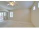 Bright bedroom featuring carpet, access to the outdoors, and a ceiling fan at 8404 Dripping Rock Ct, Las Vegas, NV 89131