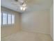 Light and airy bedroom features plantation shutters and a ceiling fan at 8404 Dripping Rock Ct, Las Vegas, NV 89131