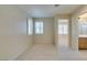 Neutral-toned bedroom with large windows and plantation shutters, with carpeted floors at 8404 Dripping Rock Ct, Las Vegas, NV 89131