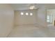 Large bedroom with plush carpeting, three transom windows, and ceiling fan at 8404 Dripping Rock Ct, Las Vegas, NV 89131