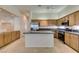 Open kitchen featuring wood cabinets, stainless appliances, granite counters, and a functional island at 8404 Dripping Rock Ct, Las Vegas, NV 89131
