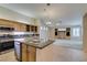 Bright kitchen featuring stainless steel appliances and a kitchen island with granite countertops at 8404 Dripping Rock Ct, Las Vegas, NV 89131