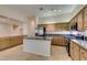 Bright kitchen with an island, wood cabinetry, granite countertops, and stainless steel appliances at 8404 Dripping Rock Ct, Las Vegas, NV 89131