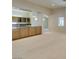 Open living space adjacent to the kitchen area with neutral carpet and recessed lighting at 8404 Dripping Rock Ct, Las Vegas, NV 89131