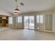 Bright living room featuring tile floors, shuttered windows, and sliding glass doors to the backyard at 8404 Dripping Rock Ct, Las Vegas, NV 89131