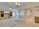 Open concept living room with built-in shelving, tile flooring, and neutral walls at 8404 Dripping Rock Ct, Las Vegas, NV 89131
