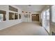 Spacious living area with tile floors and backyard access through sliding glass doors with shuttered windows at 8404 Dripping Rock Ct, Las Vegas, NV 89131