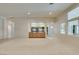 Bright living room with neutral carpet, light walls, and large windows with shutter blinds at 8404 Dripping Rock Ct, Las Vegas, NV 89131