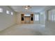 Open concept living room with built-in shelving, shutter blinds, and ceiling fan at 8404 Dripping Rock Ct, Las Vegas, NV 89131