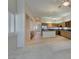 Bright living room open to the kitchen, with plantation shutters and tiled flooring at 8404 Dripping Rock Ct, Las Vegas, NV 89131