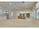 Spacious living room with neutral carpet, light walls, and a view into the kitchen at 8404 Dripping Rock Ct, Las Vegas, NV 89131