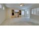 Open concept living room with built-in shelving, shutter blinds, and neutral walls at 8404 Dripping Rock Ct, Las Vegas, NV 89131