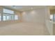 Expansive living area featuring plush carpeting and large windows with lots of natural light at 8404 Dripping Rock Ct, Las Vegas, NV 89131