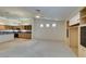 Open-concept living room and kitchen area with built-in shelving and carpeted flooring at 8404 Dripping Rock Ct, Las Vegas, NV 89131