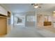 Spacious living room with built-in shelving, carpeted flooring, and natural light from the windows at 8404 Dripping Rock Ct, Las Vegas, NV 89131
